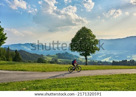 active woman riding her electric mountain bike in the Brenz Forest mountains near Sulzberg, Vorarlberg, Austria Royalty-Free Stock Photo #2171320591