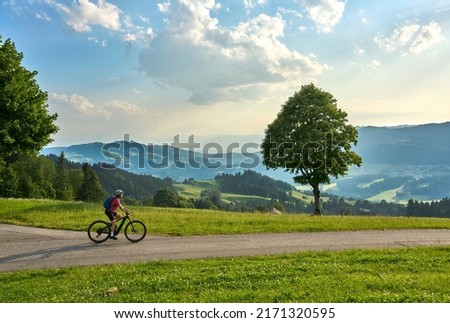 active woman riding her electric mountain bike in the Brenz Forest mountains near Sulzberg, Vorarlberg, Austria Royalty-Free Stock Photo #2171320595
