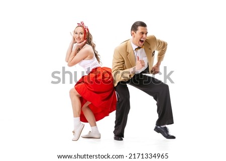 Expressive couple of dancers in vintage retro style outfits dancing social dance isolated on white background. Timeless traditions, 60s ,70s american fashion style. Dancers look excited Royalty-Free Stock Photo #2171334965