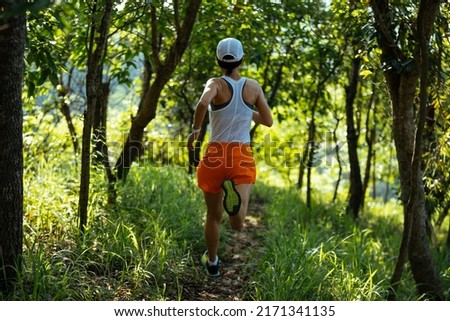 Woman runner running on forest trail
 Royalty-Free Stock Photo #2171341135