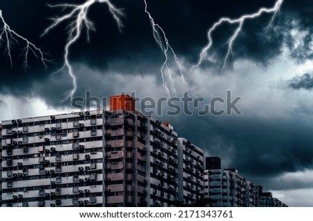 Lightning storm over the old residential area, Old apartment with dark sky and lightning.