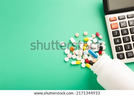 Medical concept with various medicines and calculator on blue background. High quality photo