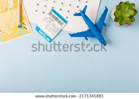 Desktop with a map, coffee and an airplane, on a blue background. Travel concept. High quality photo Royalty-Free Stock Photo #2171345881