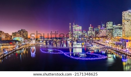 Short Bright sunset panorama of Darling harbour Cockle bay in Sydney city CBD at Vivid Sydney light festival show. Royalty-Free Stock Photo #2171348625