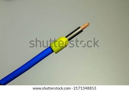 Blue wire with yellow ferrule - macro photo. Background picture. Selective focus. Royalty-Free Stock Photo #2171348853