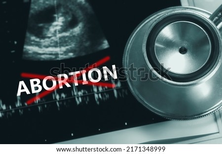 The abortion ban law. Stop Illegal healthcare. Save baby life. Abortion ruling. Anti-abortion movement. Stethoscope and ultrasound scan picture of pregnancy and fetus. Moral and ethical concepts. Royalty-Free Stock Photo #2171348999