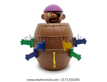 Pirate barrel pop up toy for playing lucky stab challenge with plastic knives on isolated white background.