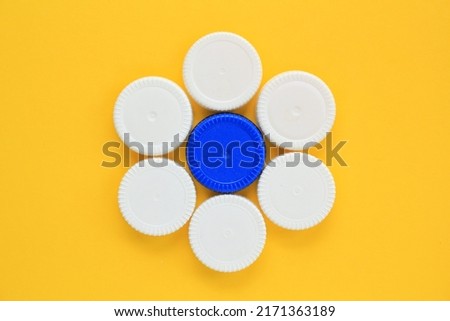 Flower pattern mosaic decoration made of colorful used plastic bottle caps on yellow background. Handmade craft.Recycling diy art.Nature pollution concept.Garbage design idea.Reuse, reduce.SHOTLISTeco