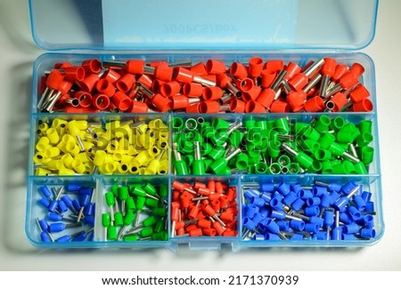 Box with colorful ferrules on the white background - close up picture. Selective focus. Royalty-Free Stock Photo #2171370939