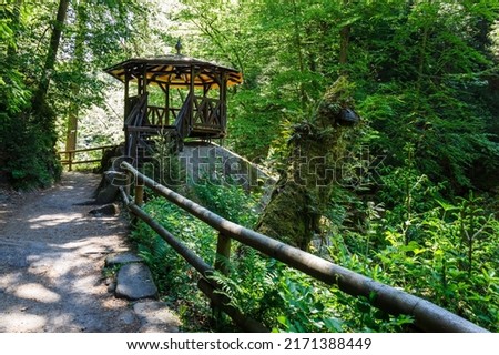 Wooden arbor near flowing Kamenice river in the Bohemian Switzerland National Park, Czech Republic. Royalty-Free Stock Photo #2171388449