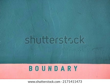 Rough green wall and pink border with word BOUNDARY, concept of to set limit in relationship which help define what you are comfortable and would like to be treated Royalty-Free Stock Photo #2171411473