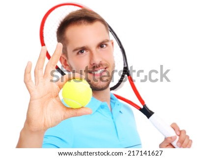 A picture of a handsome tennis player with a racket and ball over white background