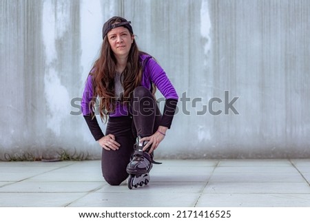 young sporty woman practicing inline skating in an urban setting. High quality photo