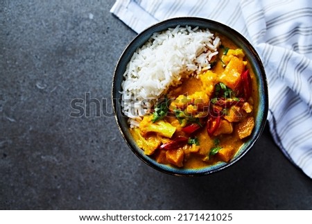Sweet potato and cauliflower curry made with coconut milk. Top view Royalty-Free Stock Photo #2171421025