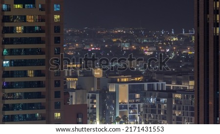 City Walk district aerial night timelapse, new urban area near Dubai downtown. Residential buildings and shopping zone behind skyscraper Royalty-Free Stock Photo #2171431553