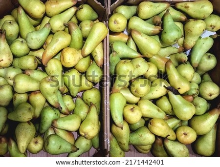 Stock photo, top view of two large boxes with many ripe juicy pears. Macro photo of sweet healthy fruit, organic healthy food. For backgrounds, design, printing, presentation