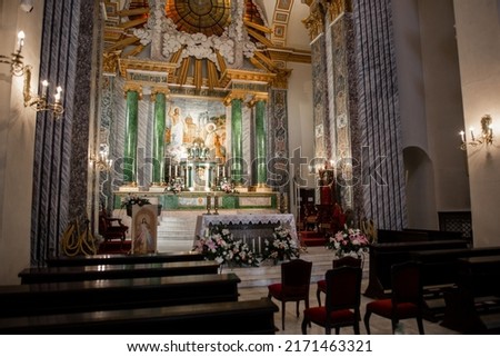 a wooden benches in a catholic church interior