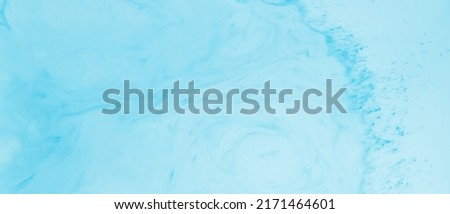 Fluid Art liquid backdrop. Blue turquoise background. Abstract background of blue-turquoise shades on liquid