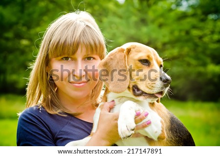 woman with beagle dog in the park