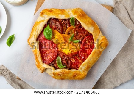 Food concept tomatoes heirloom tart pie with basil Royalty-Free Stock Photo #2171485067