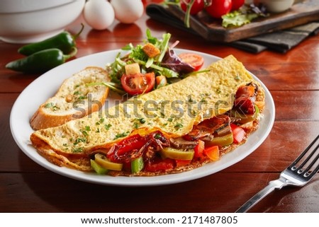 mexican omelette roll with salad served in a dish isolated on wooden background side view Royalty-Free Stock Photo #2171487805