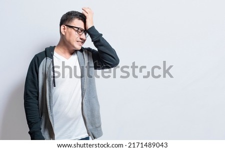 A forgetful person touching his head, A person with trouble remembering isolated, Concept of a forgetful person, People with memory problems isolated Royalty-Free Stock Photo #2171489043