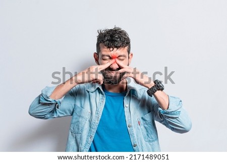 Man with nasal bridge headache, person with pain touching nose. sinus pain concept, A person with nasal bridge pain Royalty-Free Stock Photo #2171489051