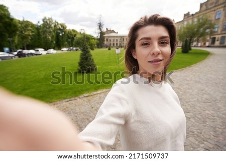 Young woman making selfie on the street