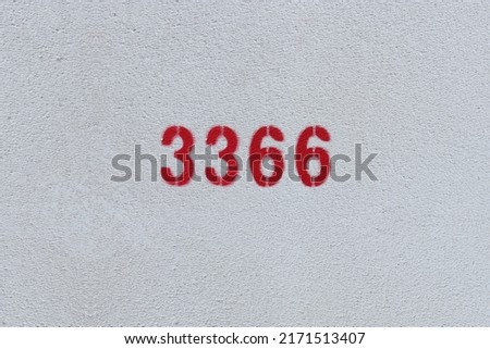 Red Number 3366 on the white wall. Spray paint.
