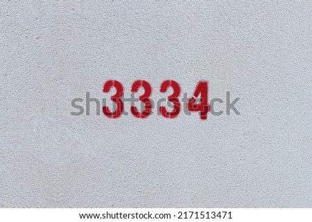 Red Number 3334 on the white wall. Spray paint.
