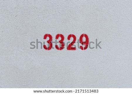 Red Number 3329 on the white wall. Spray paint.
