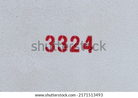 Red Number 3324 on the white wall. Spray paint.
