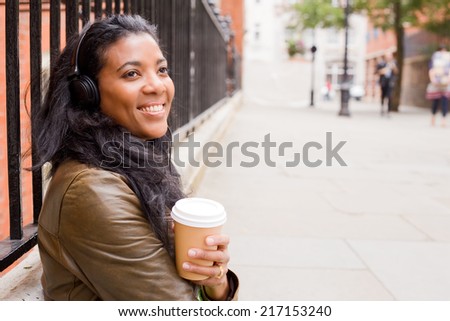 young woman enjoying coffee and music.