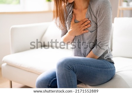 Portrait Of A Young  Woman Suffering From Chest Pain Royalty-Free Stock Photo #2171552889