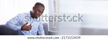 Portrait Of A Young African Man Suffering From Chest Pain Royalty-Free Stock Photo #2171553439