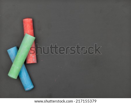 Empty clean chalkboard with red, green and blue chalk
