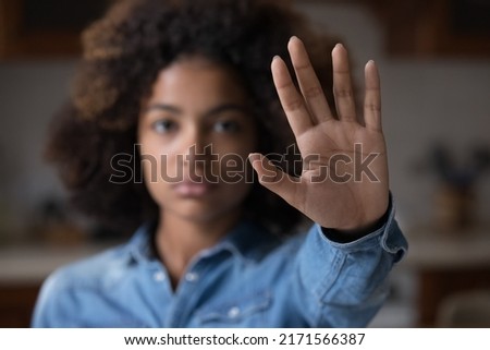 Close up focus African woman show palm hand opposes racial or gender discrimination, make stop gesture, sign of protest, female against domestic violence, abortion, bullying at school, say no concept Royalty-Free Stock Photo #2171566387