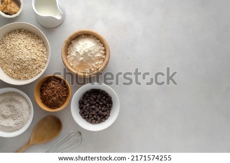 Chocolate oats brownies ingredients, cooking pastry, muffins, baking process, oat flour in bowls, copy space for text Royalty-Free Stock Photo #2171574255