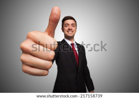 Portrait of a smiling businessman giving thumbs up