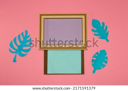 vintage frame from two parts in the first purple copy space in the second blue copy space around them pink background with blue paper jungle leaves, creative modern design