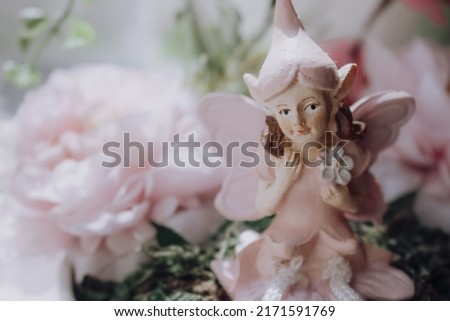 Cute flower fairy sitting between flowers.