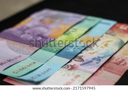 Indonesian money. Indonesian Rupiah. side corner. bokeh money photo. 100,000 rupiah.