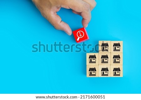 Franchise or franchising, Hand choose cube wooden toy block stack with key and franchises business store icon for goal to growth and products services or branch expansion or banking loan.