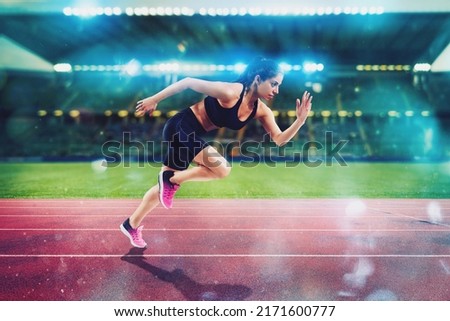 Athletic woman runs in a sport stadium