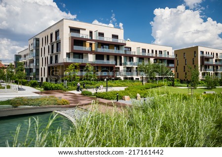 Public view of eco friendly block of flats in the green park with blue sky with few clouds Royalty-Free Stock Photo #217161442