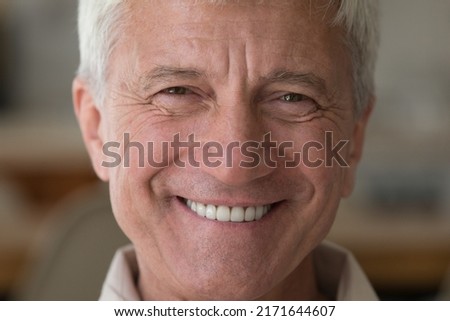 Handsome older man smiling staring at camera feels happy, close up face view. Senior advertise professional dental clinic, teeth repair and check up services, medical insurance cover for elder concept Royalty-Free Stock Photo #2171644607