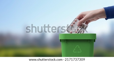 Woman putting blister packs and expired medicines in the trash bin, safe disposal of expired medications Royalty-Free Stock Photo #2171737309