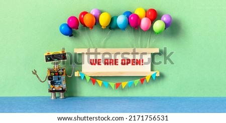 We are open. Invitation greeting card for opening ceremony, start of a project, business launch. Robot and wooden sign decorated with balloons, garland of flags. purple violet background