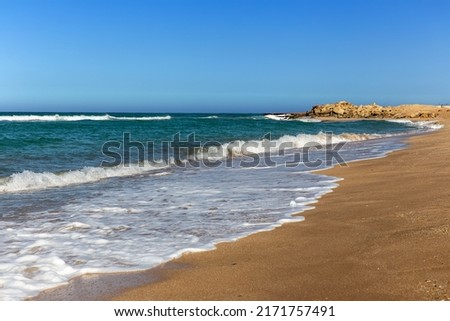 Foamy surf on a sandy tropical beach