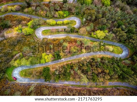 Aerial view of winding road in spring in Asturias, Spain. Royalty-Free Stock Photo #2171763295